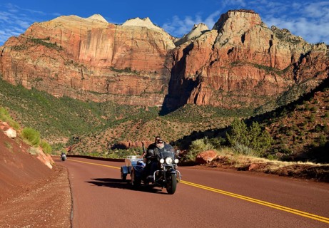 Harley Davidson motorcycle on the red road of Zion Park Boulevard - Mount Carmel U.S. Highway 9