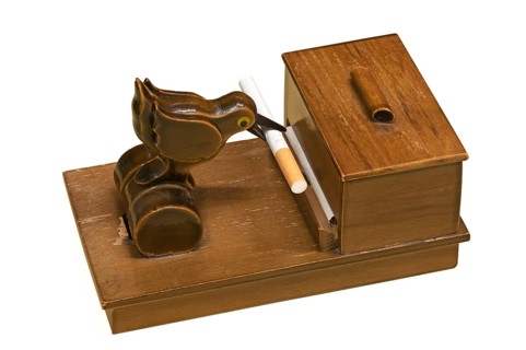 Wooden cigarette dispenser with a bird from the 1950s