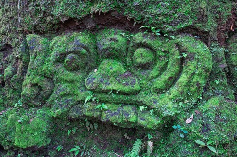 Moss-covered sculpture in the forest