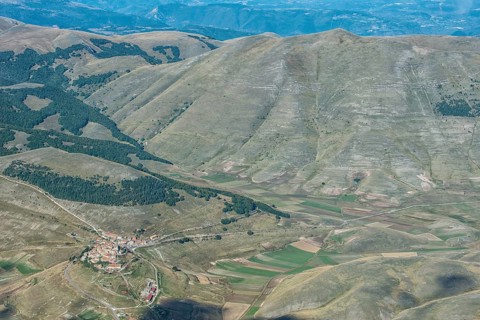 Aerial view of Piano Grande plateau and village of Castelluccio di Norcia