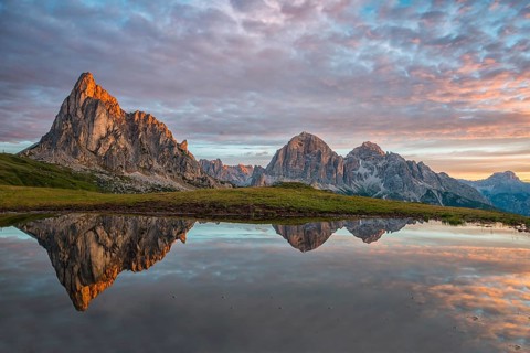 Gusela mountain at sunrise reflected in small lake