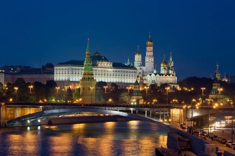 Moscow Kremlin with cathedrals and palace and Bolshoy Kamenny Bridge on Moskva River at night