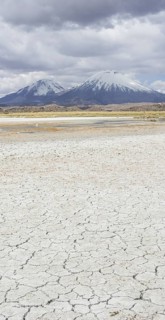 Dried up salt lake with the volcanos Parinacota