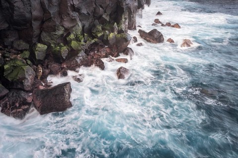 Waves of a stormy sea on the rocky coast at Cap Mechant