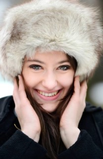 Smiling young woman wearing a fur hat