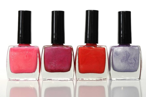 Four nail polish bottles in a row