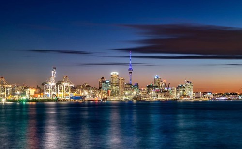 Illuminated skyline of Auckland at sunset
