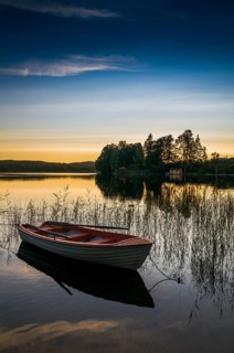 Lake and rowing boat at sunset in Bengtsfors