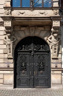 Entrance porch with bay window and atlases