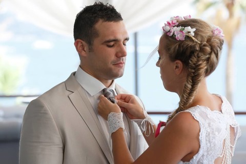 Bride adjusting the groom's tie