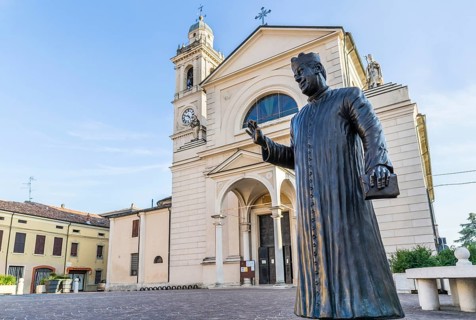 Statue of Don Camillo in Piazza Giacomo Matteotti in front of the Church of Santa Maria Nascente