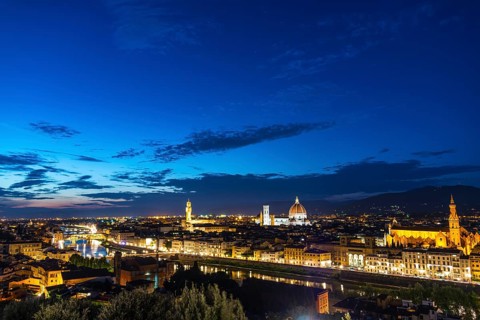 Illuminated city panorama at dusk with Florence Cathedral