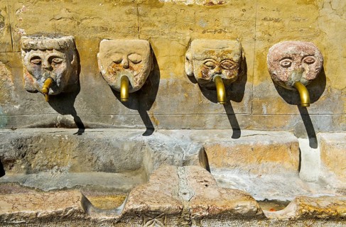 Four gargoyles by the village well
