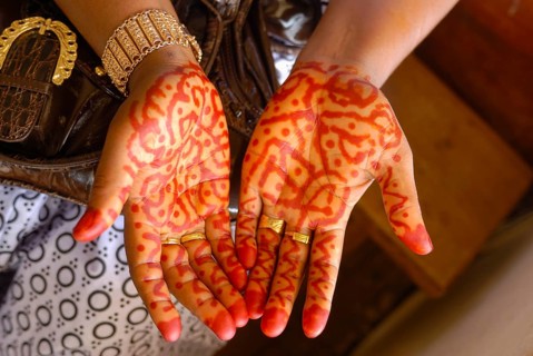 Henna-painting on hands at a wedding ceremony