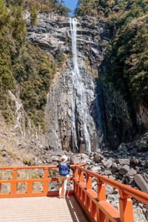 Tourist looks at Nachi Waterfall at Seigantoji Temple