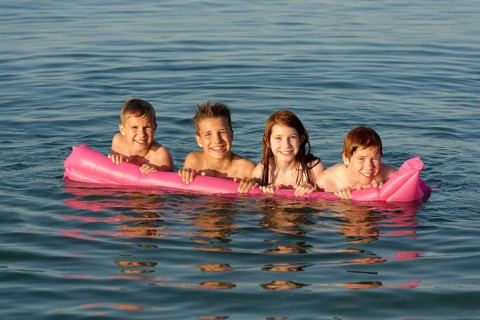 Children on a lilo in the sea