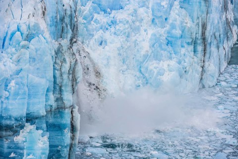 Ice breaking off the glacier wall