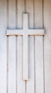 Wooden cross on the front door of a chapel
