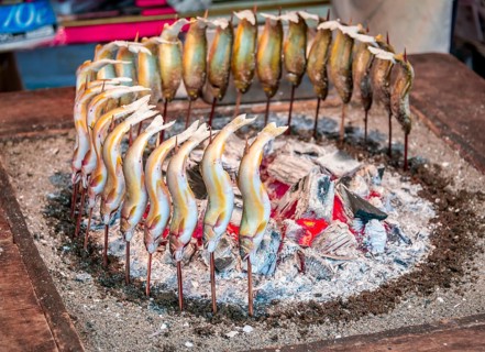 Grilled fish over fire at a food stall