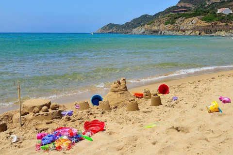 Sand castle and beach toys on the beach