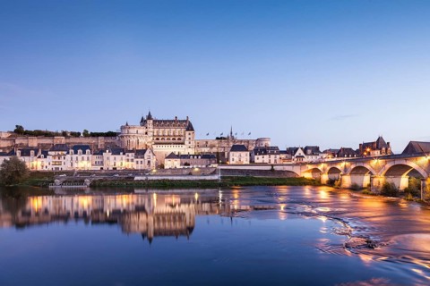 The walled town and Chateau of Amboise reflected in the River Loire in the evening