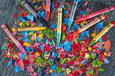 Colorful sharpened crayons on a slate