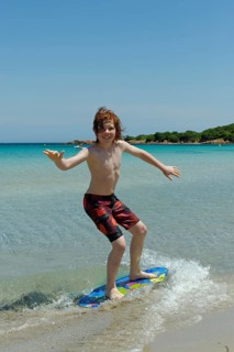 Boy surfing with his boogie board