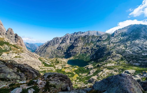 View on the mountain lake Lac de Capitello with surroundings