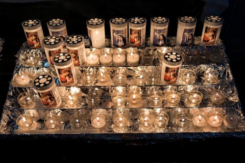 Burning votice candles in a church