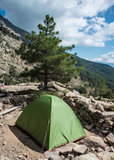 Tent on the hiking trail GR20 on the river Golo