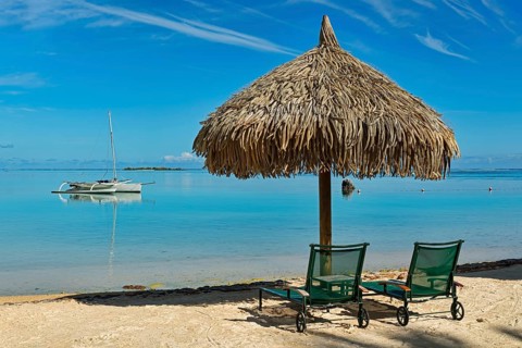 Parasol and sunloungers on the beach