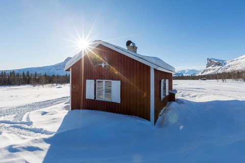 Wooden huts STF Aktse Fjallstuga in winter