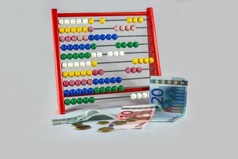 Abacus with euro notes and coins
