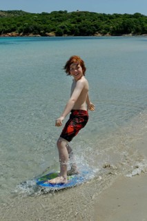 Boy surfing with his boogie board