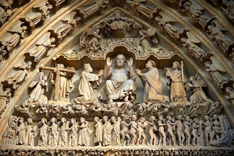 Tympanum of the central west portal showing Gothic sculptures of Christ in Majesty presiding over the Day of Judgement