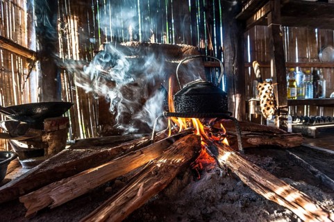 Kettle over an open fire in a kitchen made of bamboo