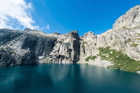 Mountain lake Lac de Melo surrounded by cliffs