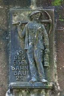 Man holding a pickaxe and a lamp