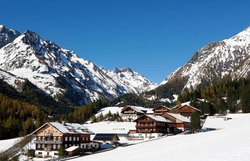 Mountain farms in a snow-capped mountain landscape