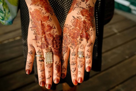 Henna-painting on hands at a wedding ceremony