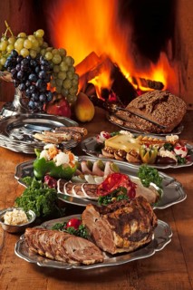 Cold Franconian buffet decorated on pewter in front of a burning fireplace