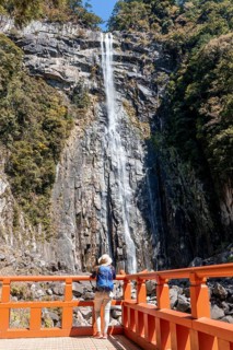 Tourist looks at Nachi Waterfall at Seigantoji Temple