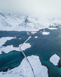 Snow-covered landscape at the fjord with Fredvang bridges