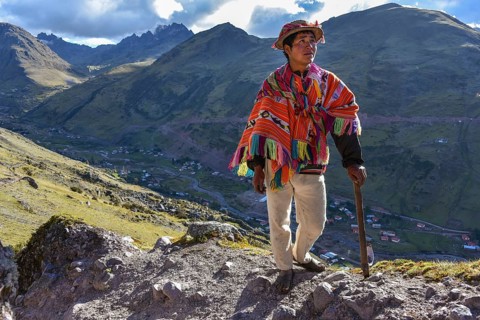 Indio mountain guide with hat and poncho in the Andes