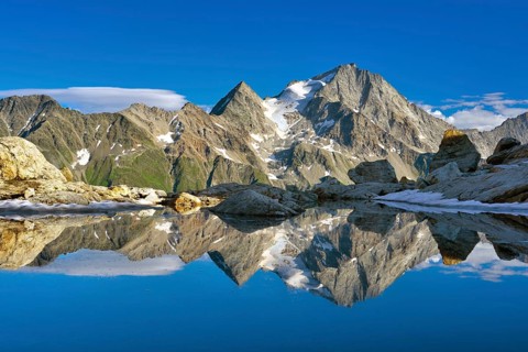 Reflection of the Oberalpstock in a mountain lake