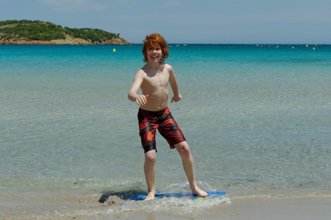 Boy surfing with his boogie board