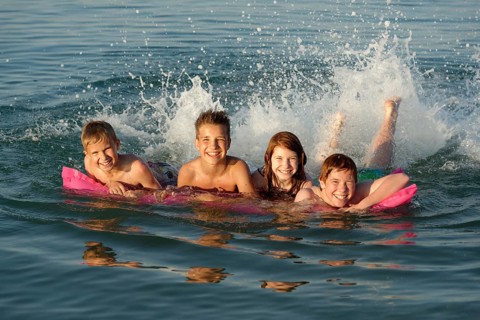 Children on a lilo in the sea