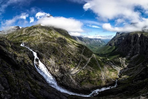 Waterfall with the Trollstigen serpentine mountain road