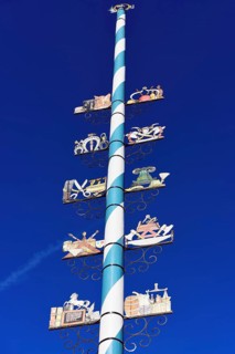 Maypole with wooden signs of local trades