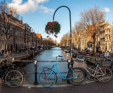 Parking bicycle on bridge over canal at Oudezijds Voorburgwal